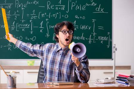 117703791-funny-male-math-teacher-in-the-classroom